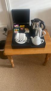 a table with a tea set on top of it at Ty Mawr Country Hotel in Carmarthen