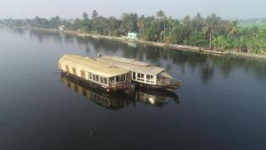 two boats sitting in the middle of a river at Green valley Alleppey in Alleppey