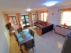 a living room with a couch and a table and chairs at Sand Castle Villa in Mont Choisy