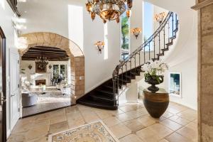 a staircase in a home with a vase of flowers at BEL AIR LUXURY VILLA 6 bed rooms in Los Angeles