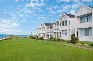 a row of apartment buildings with a green lawn at Quarterdeck 5 in Lennox Head