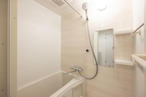 a bathroom with a shower and a mirror at Retaw Hills WASEDA in Tokyo