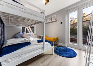 a bedroom with a bunk bed and a window at Amazing 2 Bedroom flat in London in London