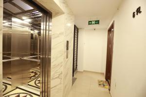 a hallway with a elevator in a building at Wins Apartment in Hanoi