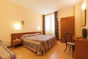 Postel nebo postele na pokoji v ubytování Hotel Fabbrini