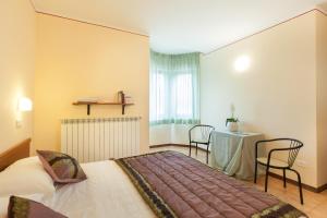 Postel nebo postele na pokoji v ubytování Hotel Fabbrini