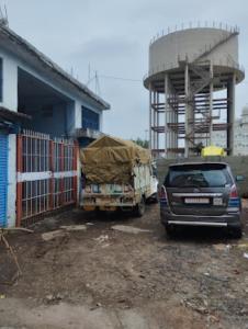 a truck parked next to a building with a water tower at HOTEL THAKUR JI,Bhopal in Bhopal