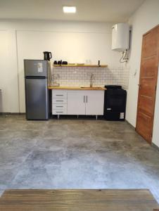 a kitchen with a refrigerator and a counter top at Casa Mar in La Lucila del Mar
