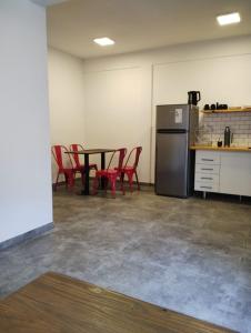 a room with a table and chairs and a refrigerator at Casa Mar in La Lucila del Mar