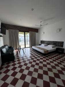 a bedroom with a bed and a checkered floor at The Orange House Santa Marta in Santa Marta