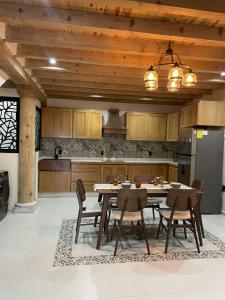 a kitchen with a table and chairs and a refrigerator at Casa Cairo Pátzcuaro in Pátzcuaro +54 photos