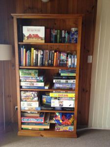 a book shelf full of dvds at The Retreat on Matthew in Batehaven +21 photos