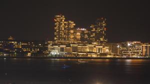 a lit up city skyline at night with the water at Apartment in Al Sufouh 1st - Comfortable Home with 5 iconic views in Dubai