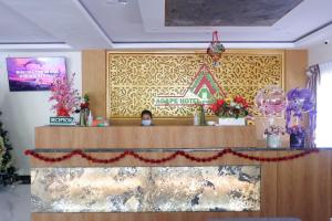 a woman standing at a counter in a salon at Agape Hotel Haranggaol in Haranggaul