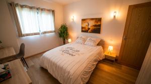 a bedroom with a bed with a white comforter at Sodnac Terraces New 2 bedroom Apartment in Quatre Bornes