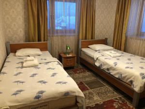 a bedroom with two beds and a window at Riia Villa in Tartu