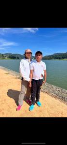 two young men standing next to a body of water at PROMAX villa in Nuwara Eliya
