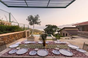 a table with plates of food on a patio at SaffronStays Sunkissed - 2 Bedroom Infinity Pool Villa in Mulshi in Mulshi
