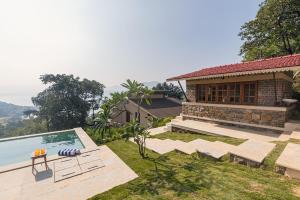 a villa with a swimming pool and a house at SaffronStays Sunkissed - 2 Bedroom Infinity Pool Villa in Mulshi in Mulshi +25 photos