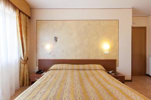Postel nebo postele na pokoji v ubytování Hotel Fabbrini