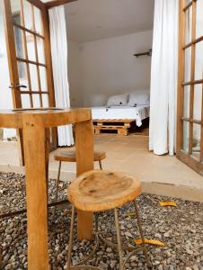 una mesa y un taburete en una habitación con cama en Hermoso Palomino en Palomino