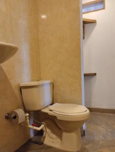 a bathroom with a white toilet in a room at Hermoso Palomino in Palomino