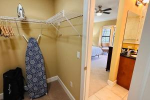 a room with a closet with a tie hanging on the wall at 4BR. Disney World Vacation Townhome in Orlando