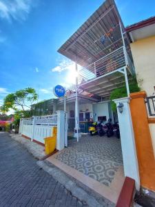 a gas station with motorcycles parked in front of it at ROOM Ijen Hostel in Banyuwangi