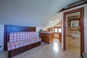 a bathroom with a bench and a sink at Studio Placide Mountain View - Happy Rentals in Sauze dʼOulx