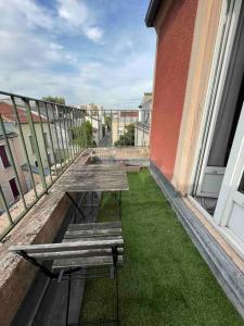 three benches sitting on a balcony of a building at Quiet cosy and bright apartment with Terrace in Saint-Ouen