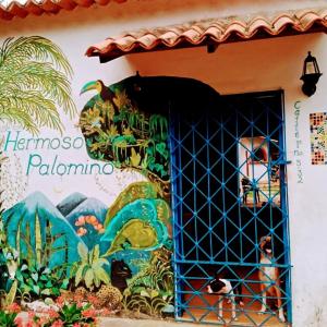 a building with a painting on the side of it at Hermoso Palomino in Palomino