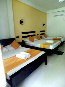two beds in a room with at AMRON RESORT SIGIRIYA in Sigiriya
