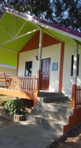 a small house with stairs leading up to it at สวนทุเรียน นันนัน มีดี รีสร์อท 