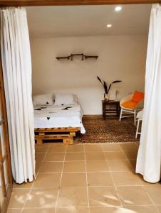 a bedroom with a bed and curtains in a room at Hermoso Palomino in Palomino