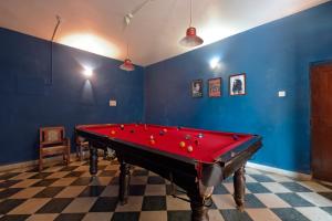 una mesa de billar roja en una habitación con paredes azules en Skylark Resort, en Colva