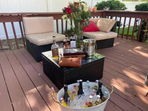 a deck with a table with a bucket of drinks at BBQ, Beats, Hot Tub Retreat in Baldwin