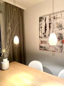 a dining room with a table and two lights at Harz is calling in Hahnenklee-Bockswiese