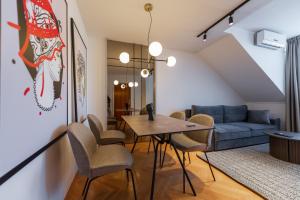 a living room with a table and chairs and a couch at Sarajevo Central Elegance Apartments in Sarajevo