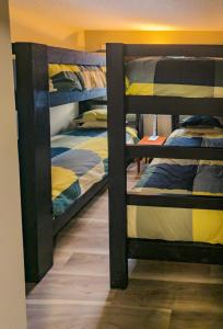 a group of bunk beds in a room at 2 Bedroom and Wall Bed Mountain Getaway Ski In Ski Out Condo with Hot Pools Sleeps 8 in Panorama