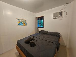 1 dormitorio pequeño con 1 cama y TV en The Surf House Pacifico, en San Isidro