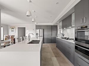 a kitchen with a large white counter top and appliances at Park View in Margaret River Town
