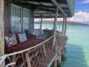 a porch on a boat in the water at Salacia's Suite in Koh Rong Island