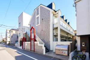a building with a red arrow on the side of it at SC 103 Cozy Private Stay with Loft Near Station Free WiFi in Tokyo