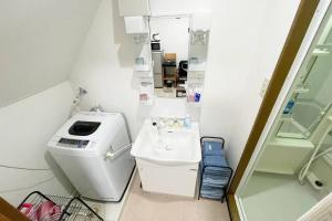 a small bathroom with a sink and a toilet at Rainbow House in Osaka