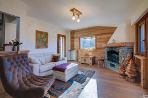 a living room with a couch and a fireplace at Danda Terrace Apartment - Happy Rentals in Sauze d'Oulx