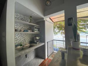 a kitchen with a sink and a view of the ocean at MONTECRISTO in San Pablo
