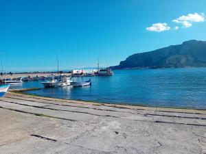 a group of boats docked in a body of water at Beach house in Mondello