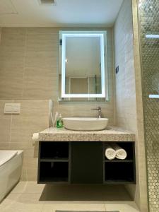 un baño con lavabo y espejo en AXQUISITE SUITES at KLCC, en Kuala Lumpur