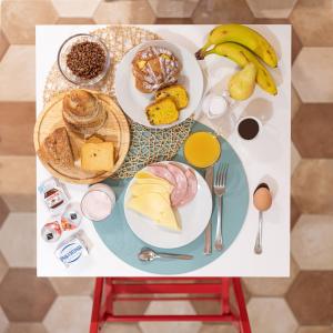 a table topped with plates of food and fruit at Top Floor Colosseo Guesthouse in Rome