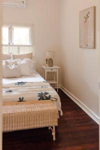 a white bedroom with a bed and a window at Pet Friendly Family Home in Bluff Point in Geraldton